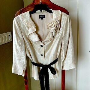Elegant off white blouse with floral
Collar and black tie and buttons.
